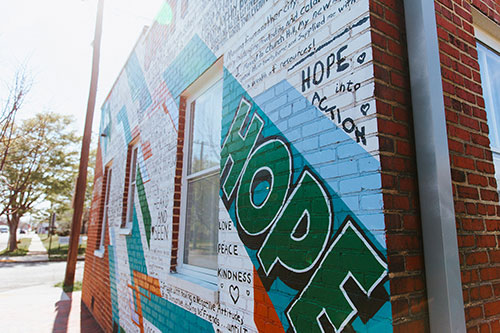 A giving wall mural featuring the message 'Hope'